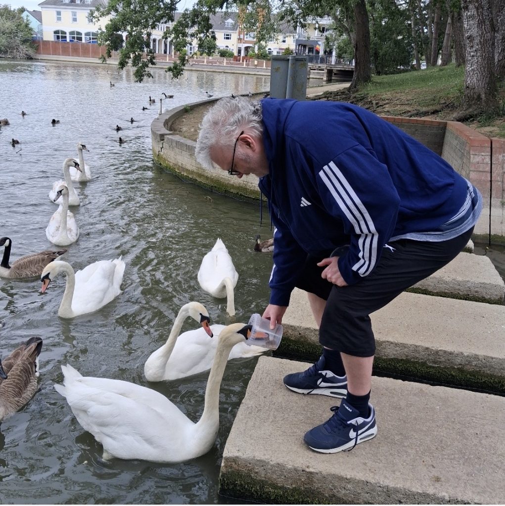 Client out for a walk feeding the ducks with help of PA Jackie